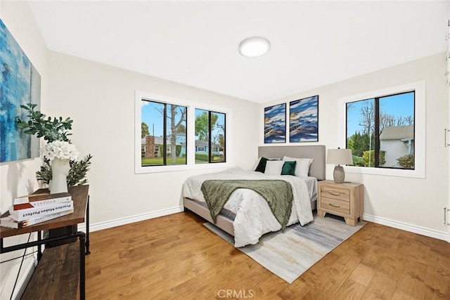 bedroom featuring baseboards and wood finished floors