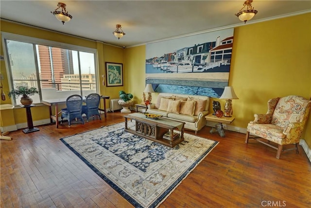 living area featuring ornamental molding, radiator heating unit, baseboards, and hardwood / wood-style floors