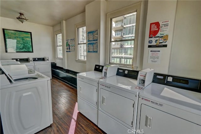 common laundry area with dark wood finished floors and washer and dryer