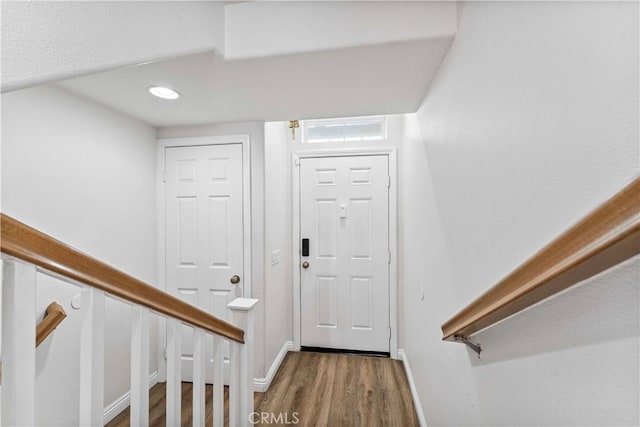 entryway with stairs, recessed lighting, wood finished floors, and baseboards