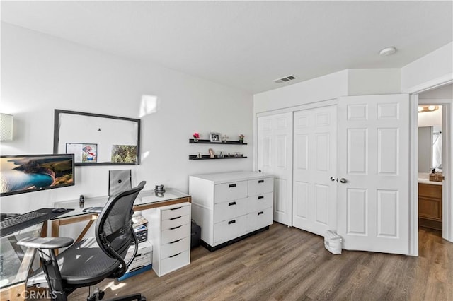 office space featuring visible vents and wood finished floors