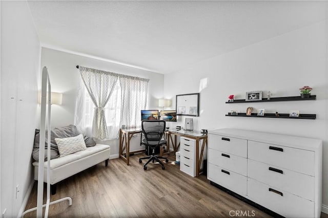 office featuring baseboards and wood finished floors