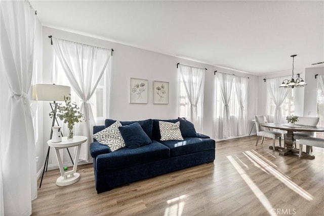 living area with a notable chandelier and wood finished floors