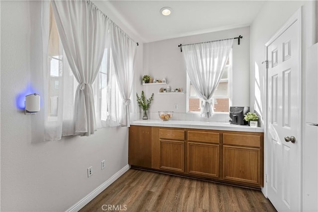 interior space with dark wood finished floors and baseboards