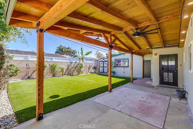 view of patio / terrace featuring a fenced backyard, an outdoor structure, and a storage shed