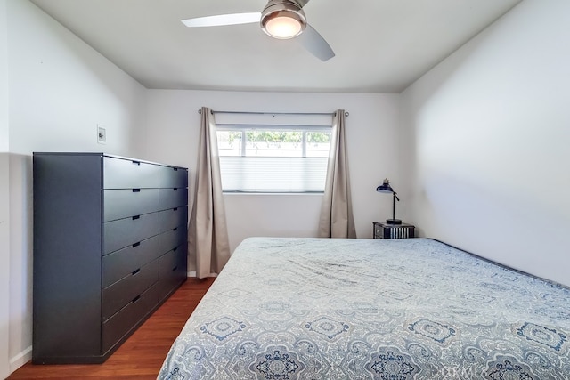 bedroom with ceiling fan and dark wood-type flooring