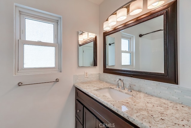 bathroom with backsplash and vanity