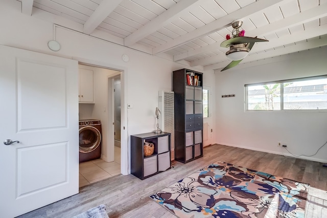 interior space with light wood-type flooring, wood ceiling, lofted ceiling with beams, and washer / clothes dryer