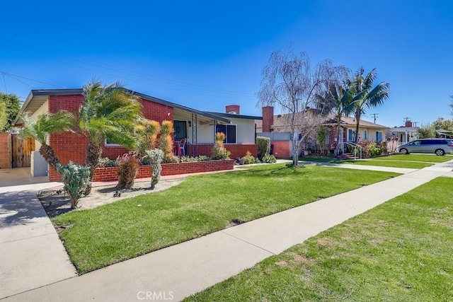 single story home with brick siding, fence, and a front yard