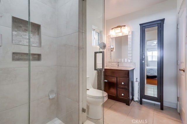 full bathroom with toilet, ensuite bath, tile patterned floors, a tile shower, and vanity