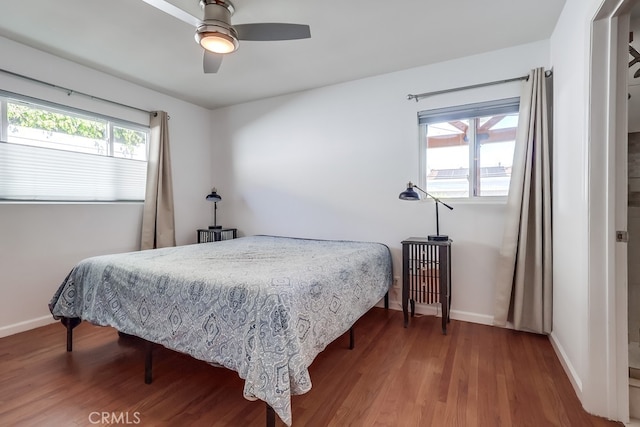 bedroom with ceiling fan, baseboards, and wood finished floors