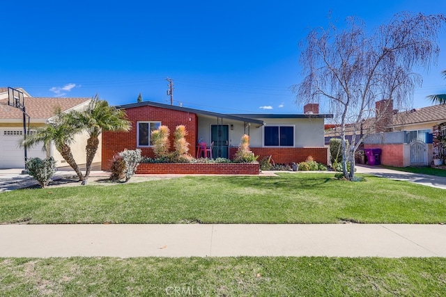 single story home featuring a garage, a front yard, brick siding, and driveway