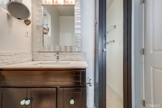 bathroom featuring tile patterned flooring, vanity, and decorative backsplash