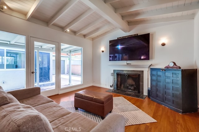 living area featuring baseboards, wooden ceiling, wood finished floors, vaulted ceiling with beams, and a fireplace