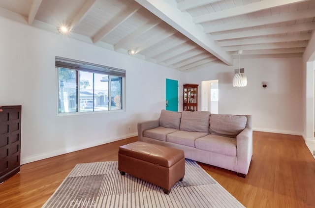 living room with vaulted ceiling with beams, baseboards, and wood finished floors