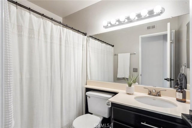 bathroom featuring toilet, visible vents, and vanity