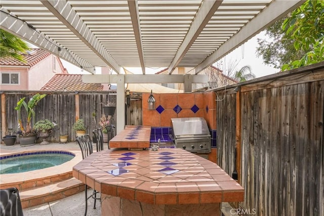 view of patio / terrace featuring an in ground hot tub, a fenced backyard, and a grill