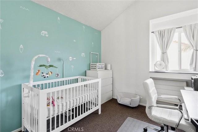 bedroom featuring vaulted ceiling, carpet floors, a crib, and baseboards