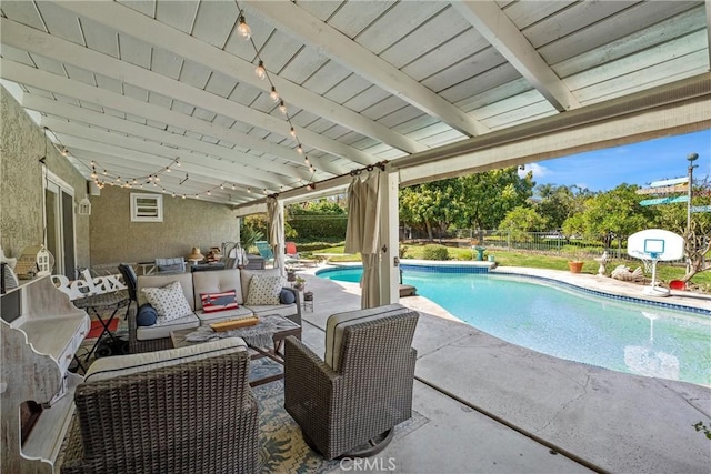 outdoor pool with a patio, fence, and an outdoor hangout area