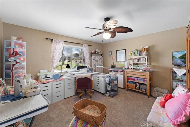 carpeted office space with ceiling fan