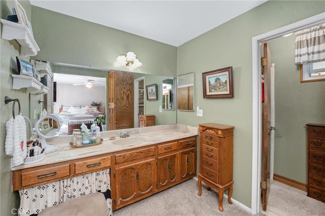 bathroom with a ceiling fan, vanity, and baseboards