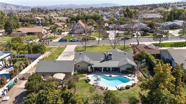 drone / aerial view featuring a residential view and a mountain view