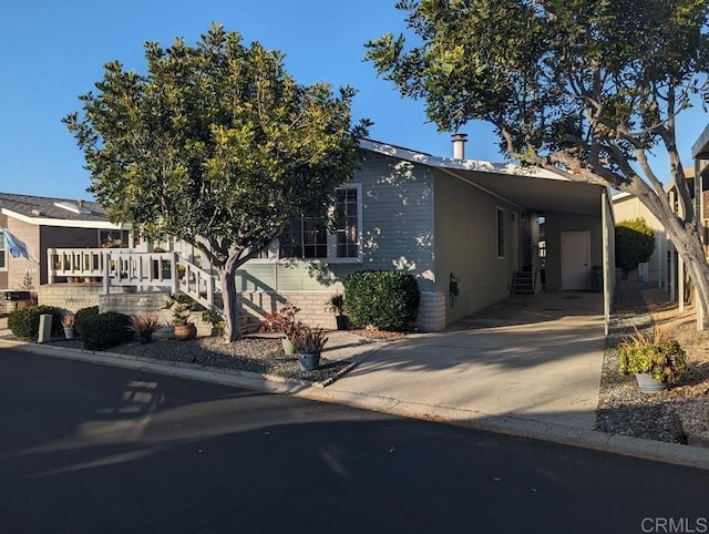 view of front of home with an attached carport and concrete driveway