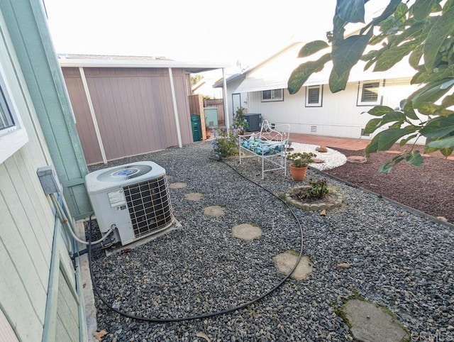 view of yard with central AC unit and a patio