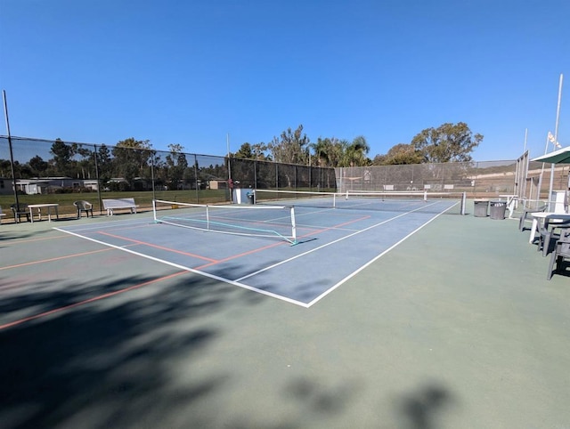 view of tennis court with fence