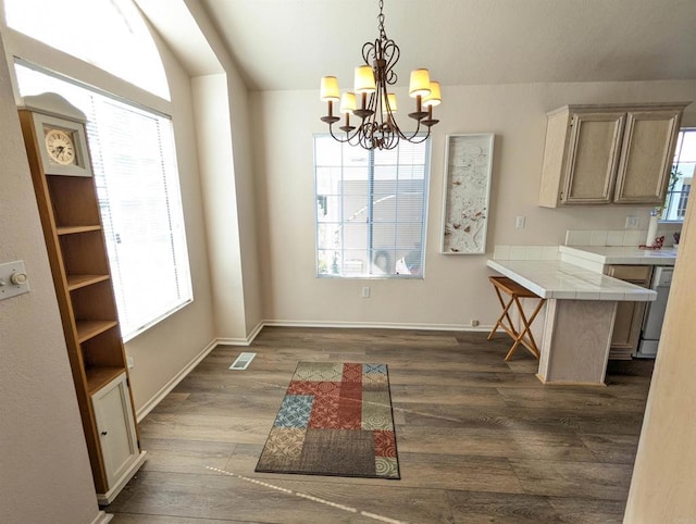 dining area with a notable chandelier, visible vents, baseboards, and dark wood-style flooring