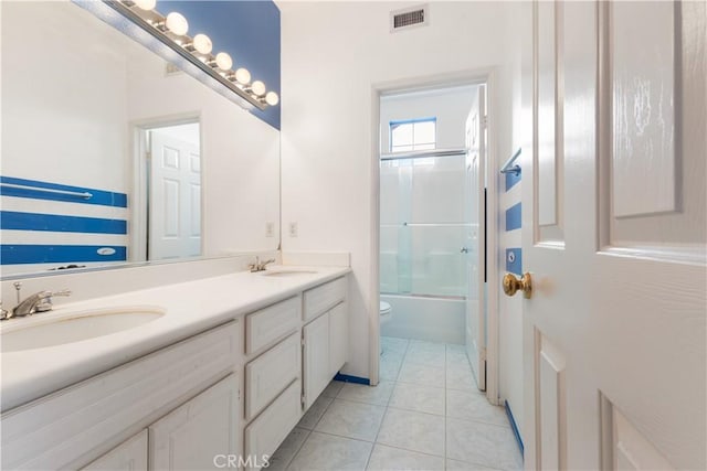 full bath with toilet, tile patterned flooring, visible vents, and a sink