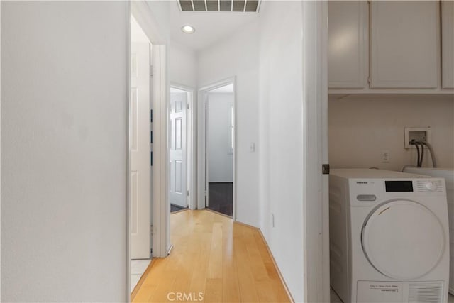 laundry area with recessed lighting, visible vents, light wood-type flooring, cabinet space, and washer / clothes dryer