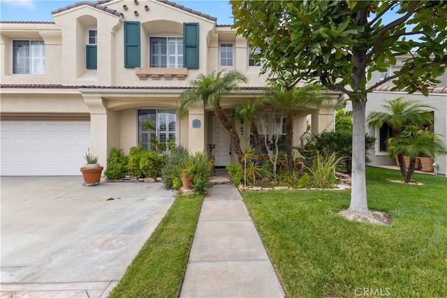 mediterranean / spanish-style home with a garage, a tile roof, driveway, stucco siding, and a front yard