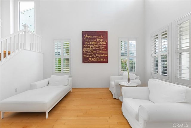 interior space featuring stairway, a high ceiling, and wood finished floors