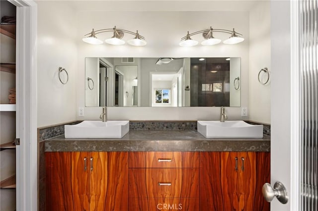 full bathroom featuring visible vents, a sink, and double vanity