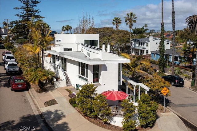 view of front facade with a residential view and stucco siding