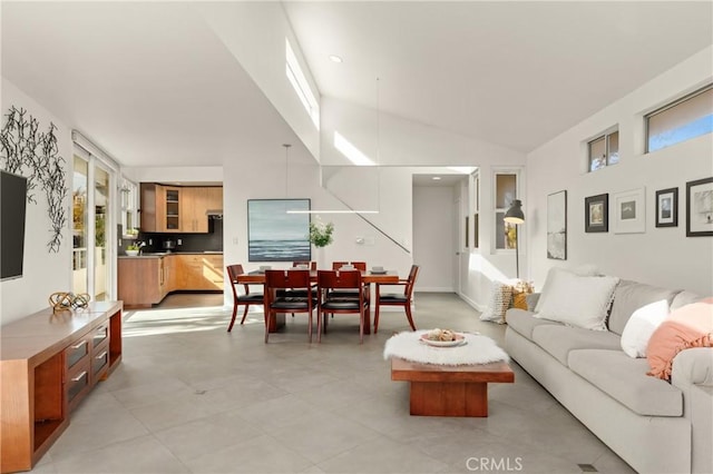 living room with high vaulted ceiling