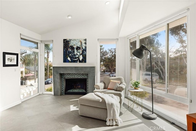 living area featuring high vaulted ceiling and a fireplace