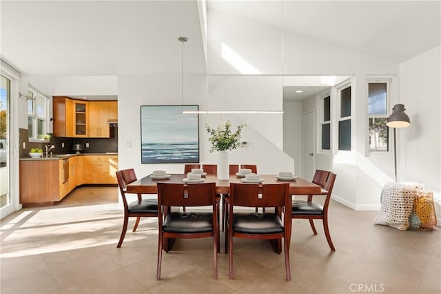 dining space with vaulted ceiling