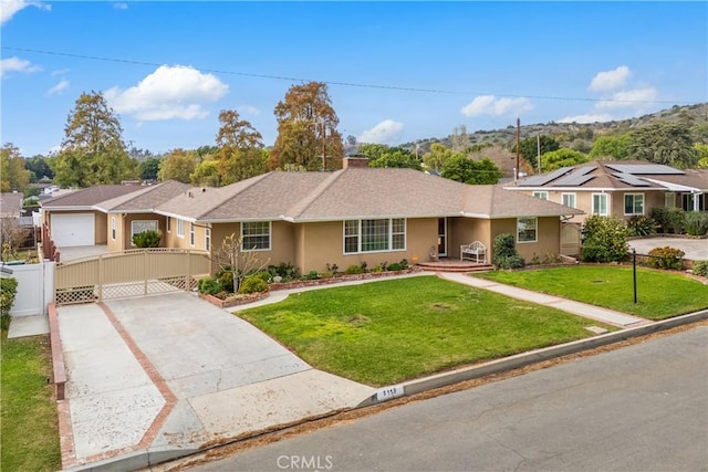 ranch-style home with fence, concrete driveway, a gate, stucco siding, and a front lawn