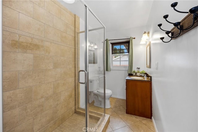 bathroom featuring toilet, vanity, baseboards, a shower stall, and tile patterned floors