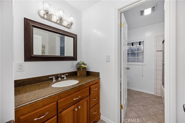 bathroom with tile patterned flooring, toilet, visible vents, vanity, and baseboards