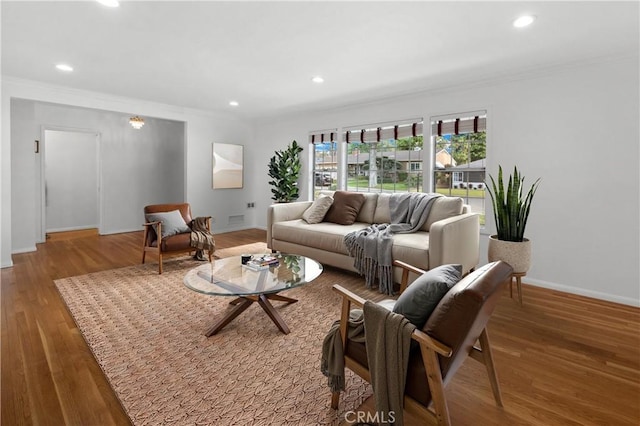 living area with baseboards, wood finished floors, and recessed lighting