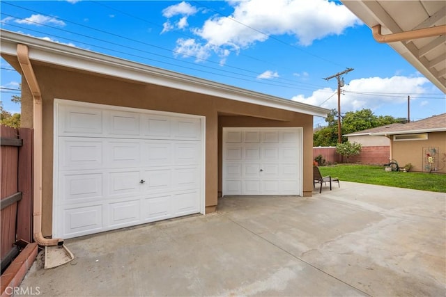 detached garage featuring fence