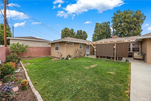 back of house with a yard, a patio, a fenced backyard, and stucco siding