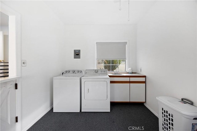 clothes washing area featuring laundry area, baseboards, washer and dryer, dark carpet, and a sink