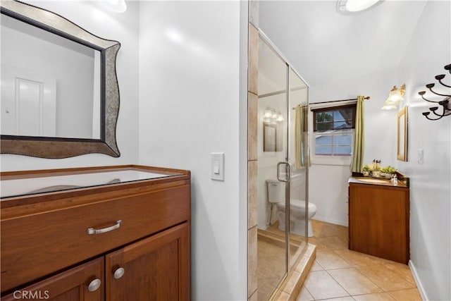 full bathroom featuring toilet, a stall shower, tile patterned floors, and vanity