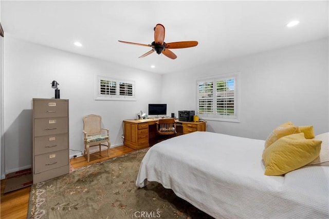 bedroom featuring baseboards, wood finished floors, and recessed lighting