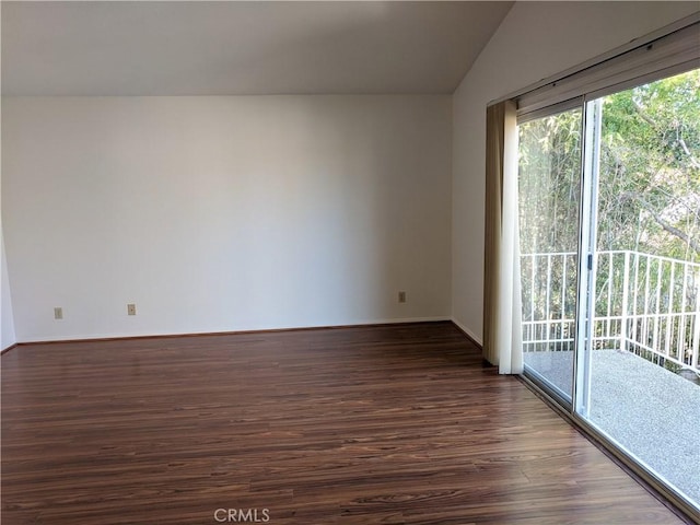 unfurnished room featuring vaulted ceiling, baseboards, and dark wood finished floors