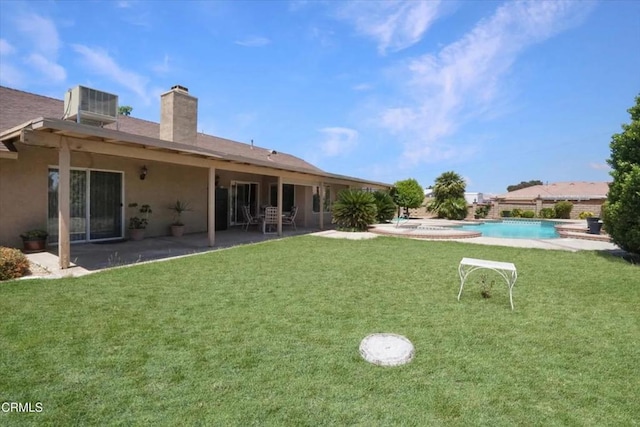 back of property featuring a patio, cooling unit, and a yard